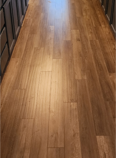 20230202_165154 3 (1) a wood floor with drawers and a light shining on it