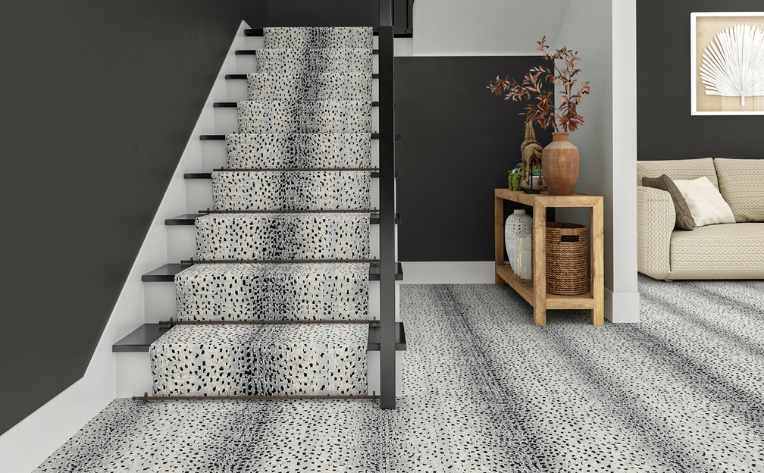 a staircase with a black and white carpet