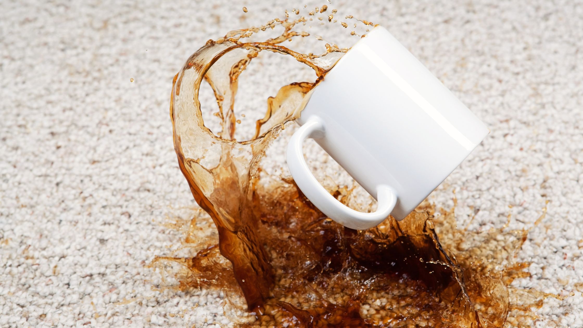 a coffee splashing out of a white mug