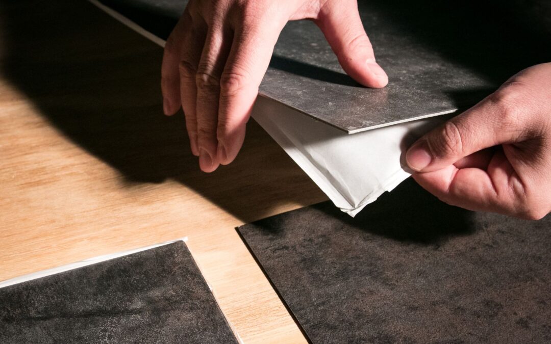 Hands placing sheets on surface