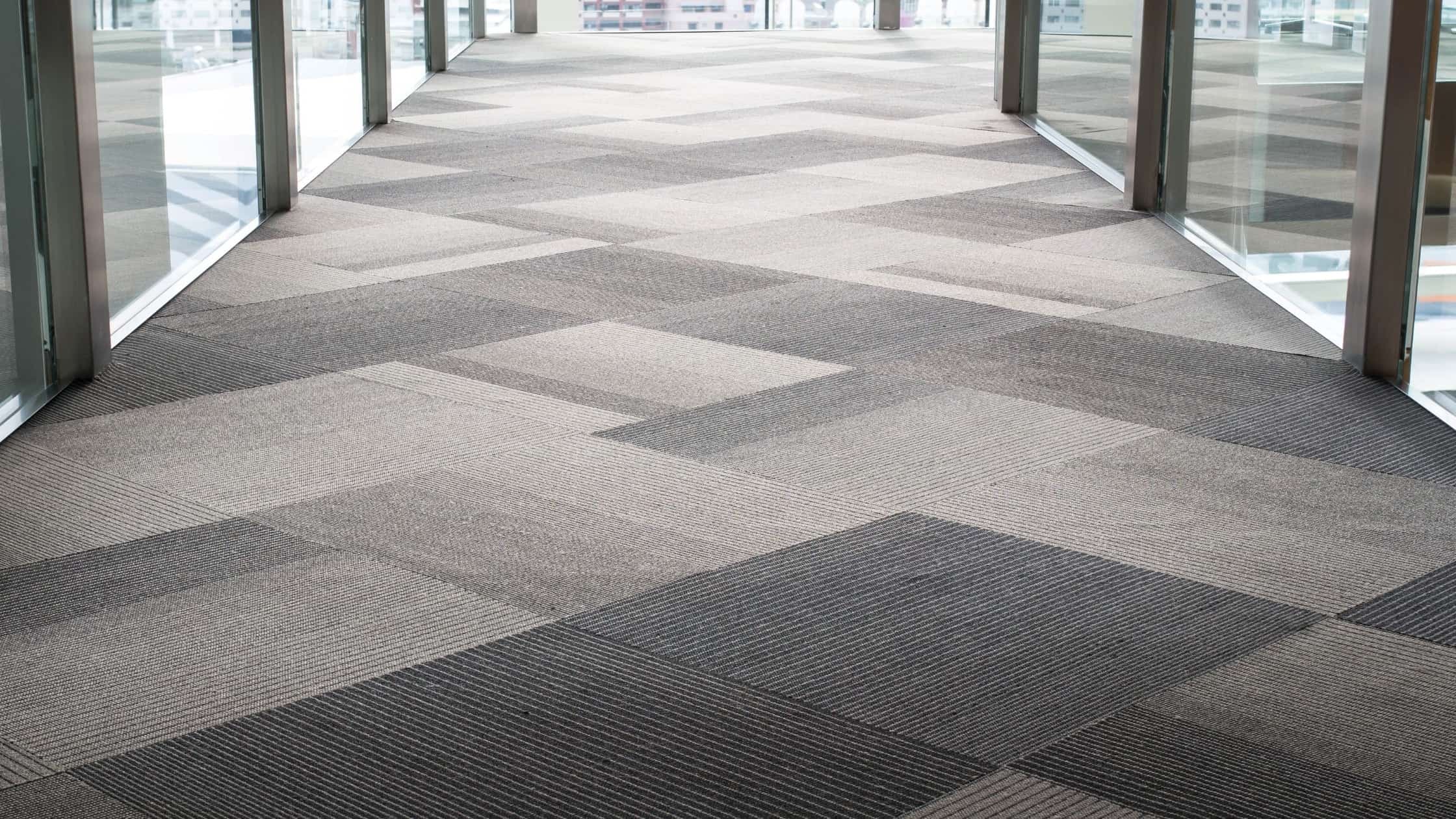 Commercial carpet flooring with geometric pattern in neutral tones at Oregon Floor Works.