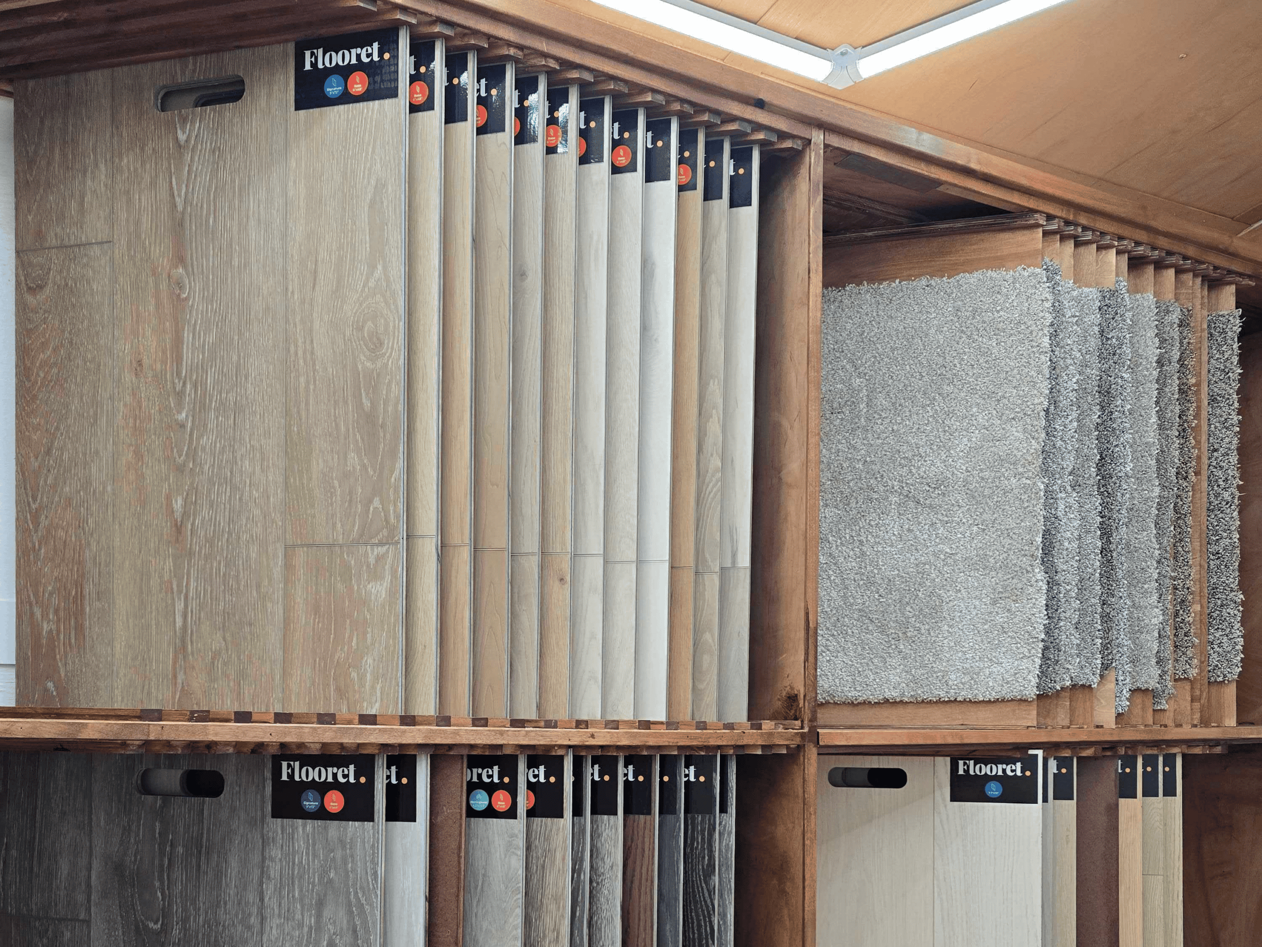 Wide selection of wood flooring samples displayed on racks at Oregon Floor Works.
