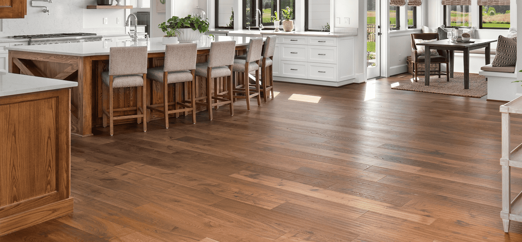 Beautiful hardwood flooring in a modern kitchen and dining area.