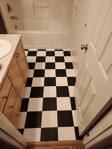 Bathroom floor with black and white checkered tiles.