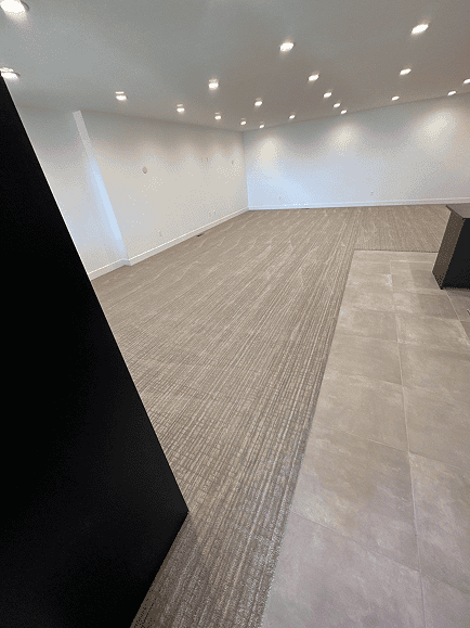 Interior office space with new carpet and tile flooring, bright lighting, and clean design.
