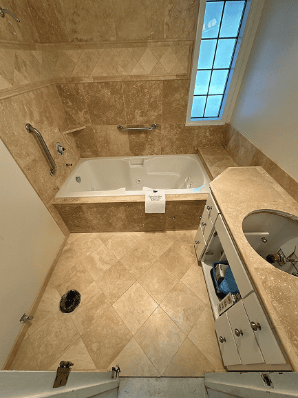 Luxury bathtub with grab bars in a modern bathroom setting.