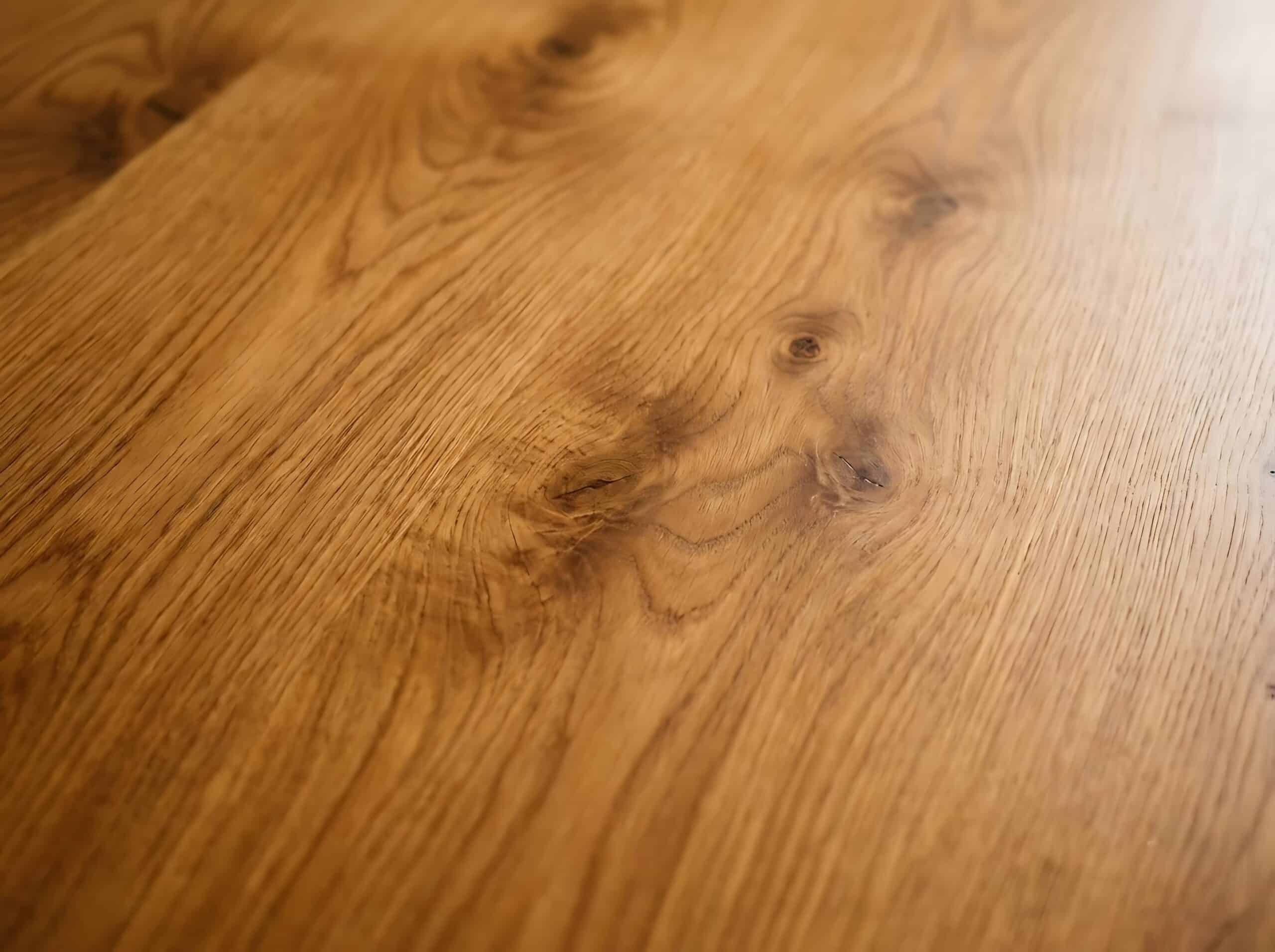 Close-up of a polished wooden floor showcasing natural grain and knots.
